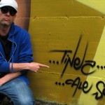 Simone "Tinez" Martinelli, grafitti artist, poses in front of his work.