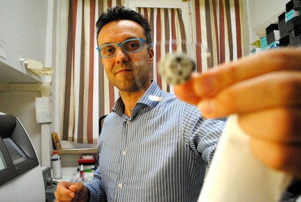 Lorenzo Paioneini displays a freshly cut lens. Paioneini manufactures custom eyeglasses created in the Stilottica lab.